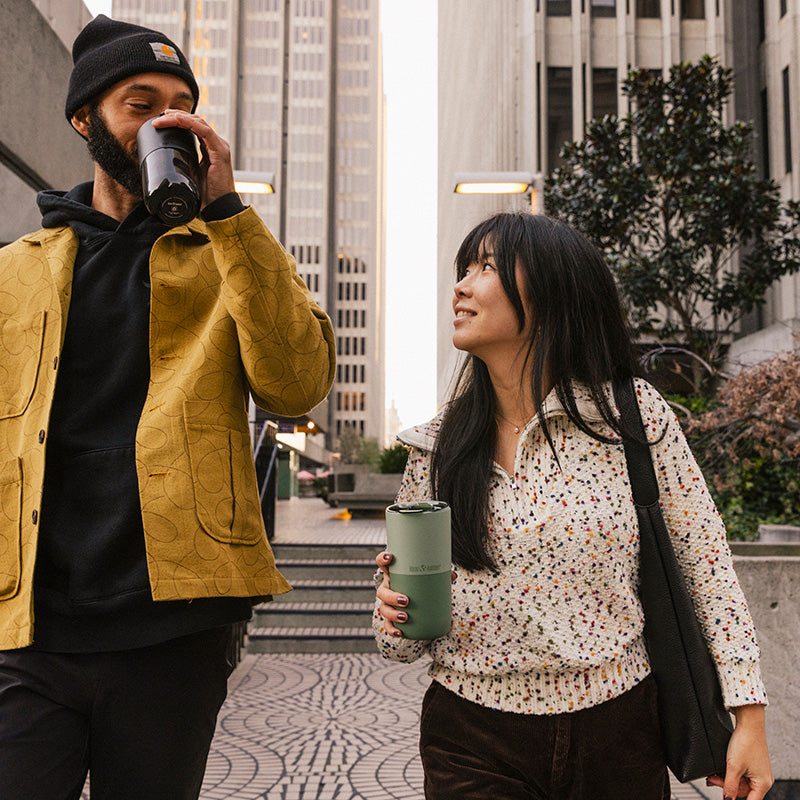 16oz-rise-tumbler-y8 16oz_rise_tumbler_black_iceberg_couple_drink_city_street_square.jpg