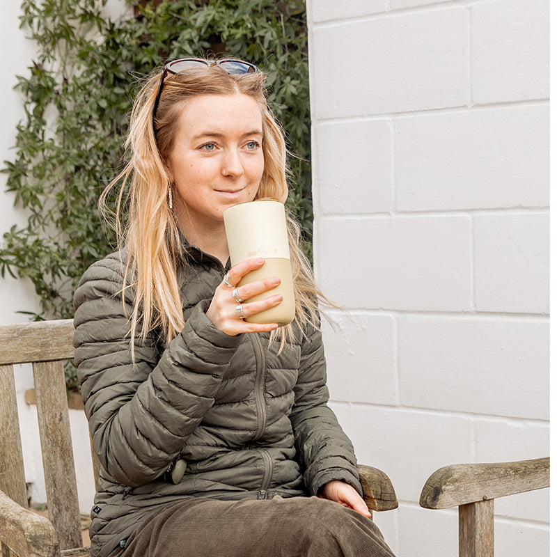 16oz-rise-tumbler-y8 16oz_rise_tumbler_wax_yellow_woman_seat_outside_square.jpg